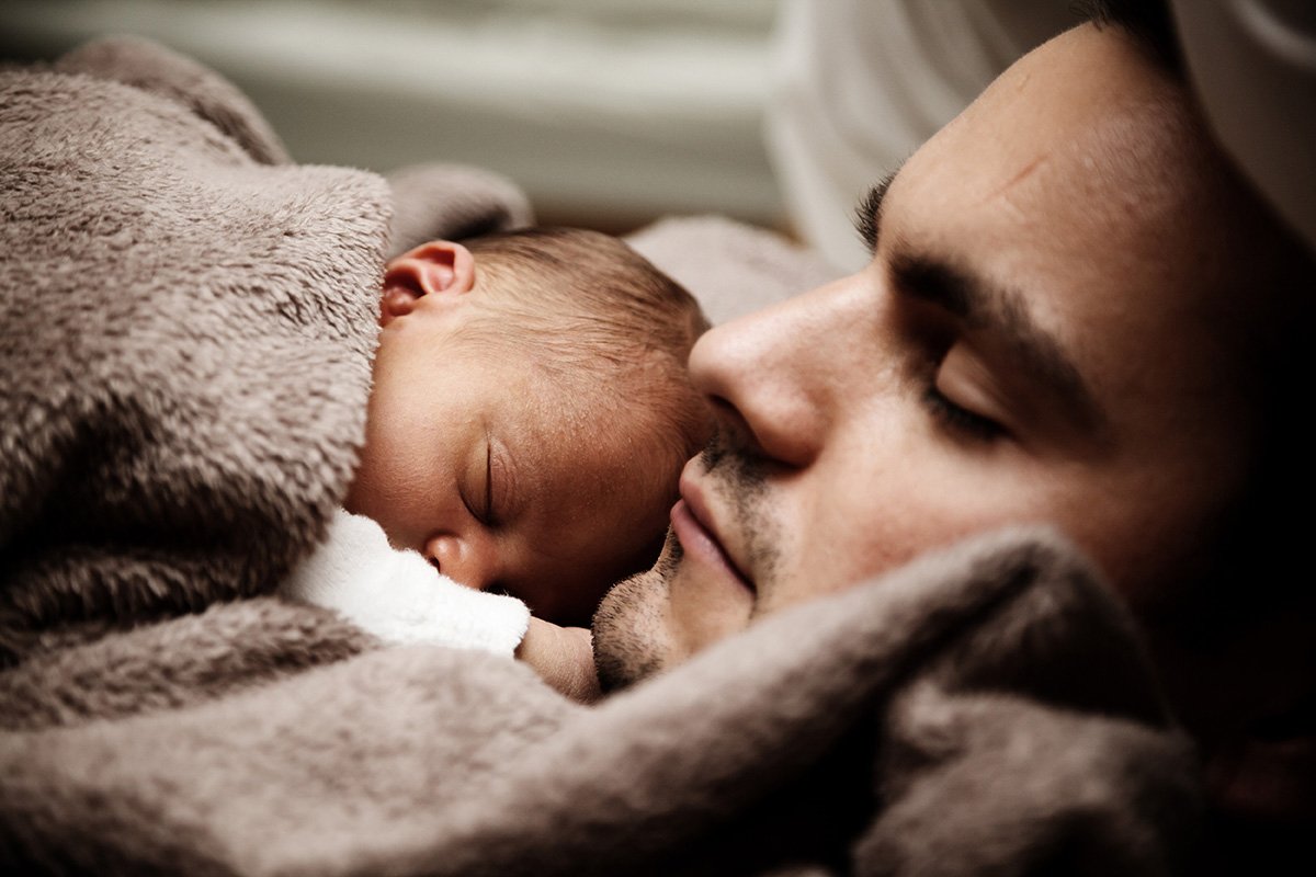 Co-Parenting - an image of a father and toddler sleeping